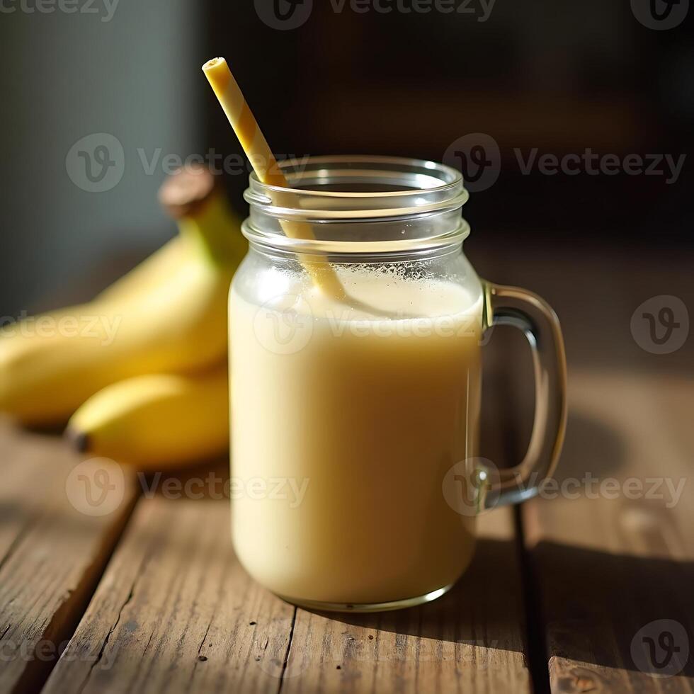 Banana Smoothie in Glass Jar with Straw on Rustic Wooden Table photo