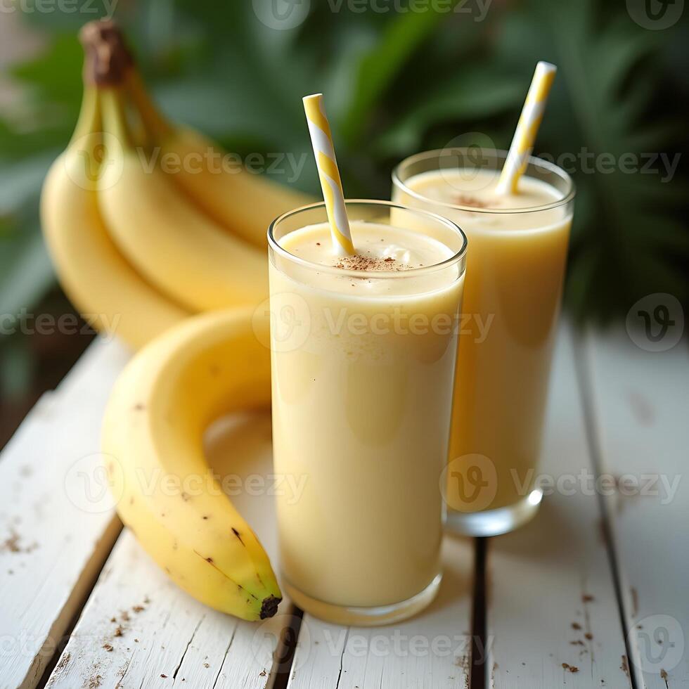 Serving Banana Smoothie with Straw on White Wooden Table photo