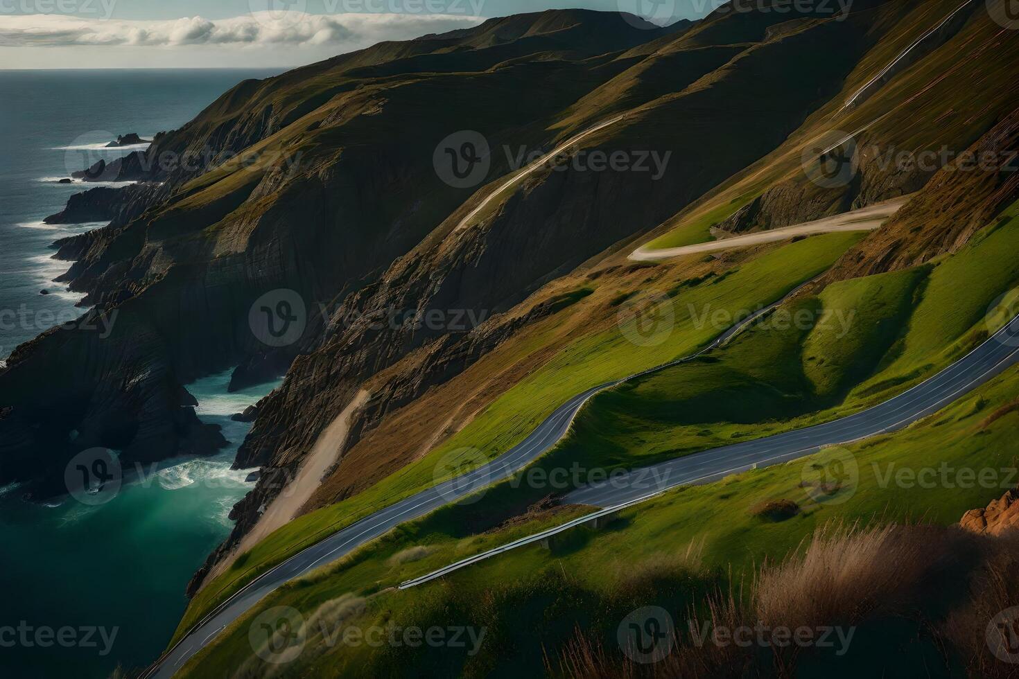 A scenic road winding through the mountains near the ocean photo