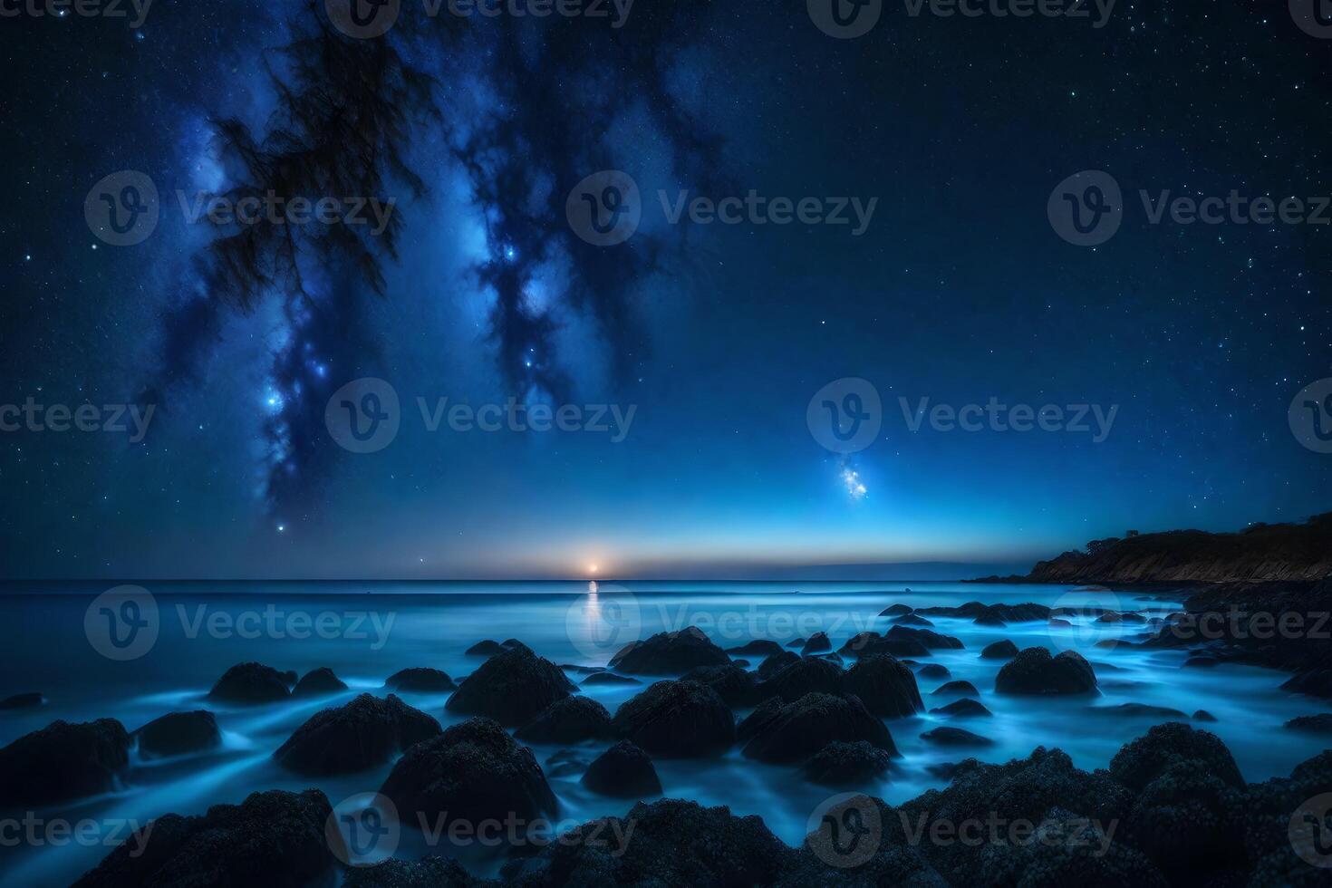 The moon and stars are shining over the ocean photo