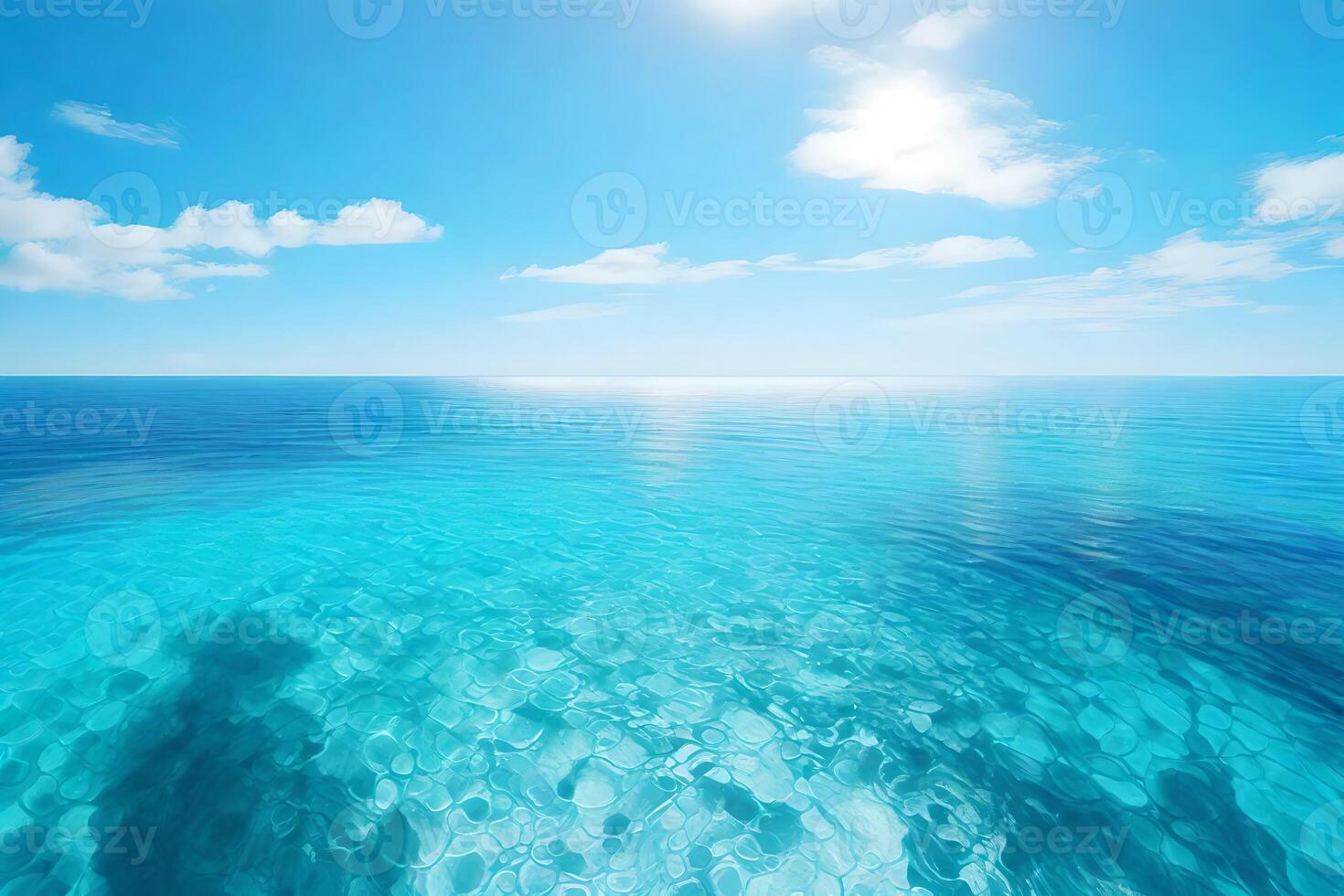 A blue ocean with clear water and sun photo