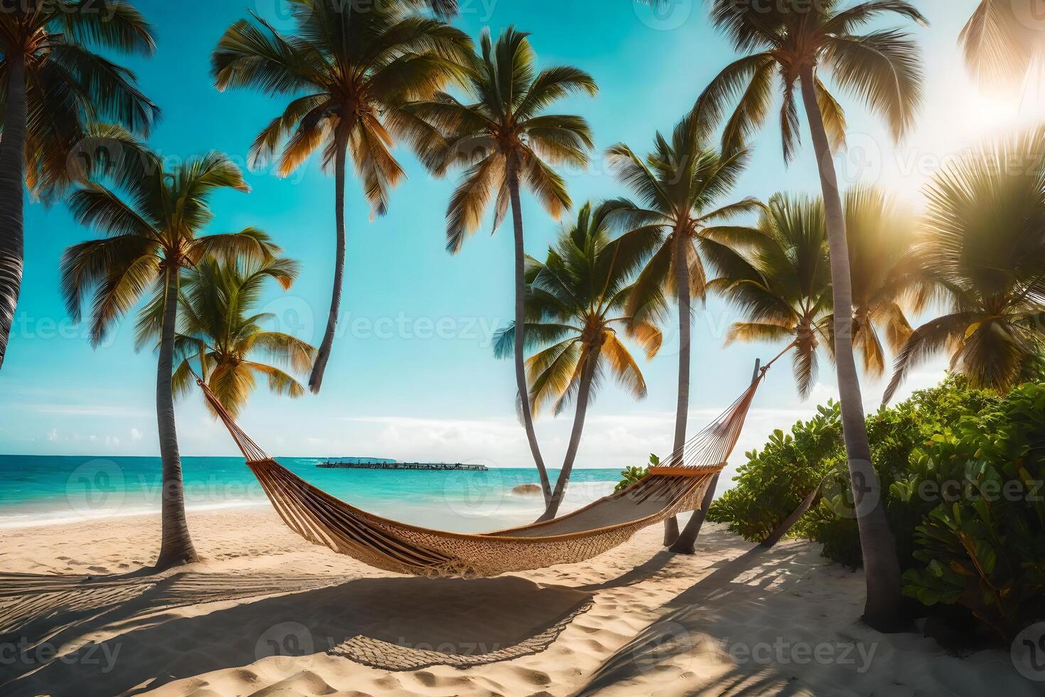 Hammock on tropical beach with palm trees photo