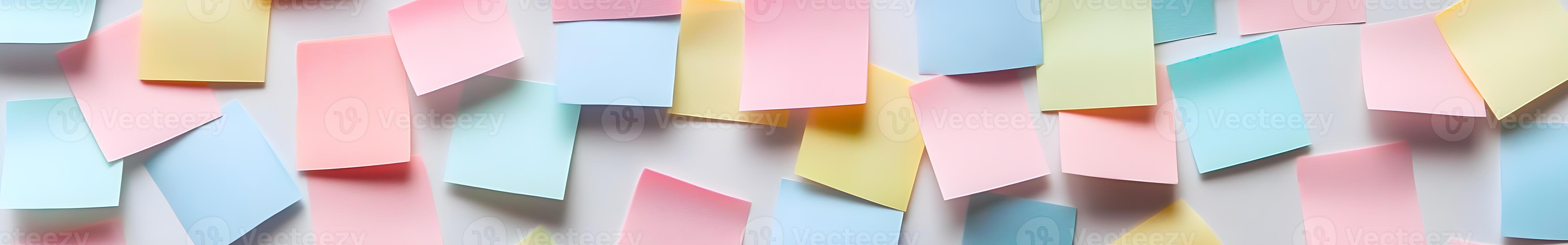 Assorted colorful sticky notes arranged on a light background. photo