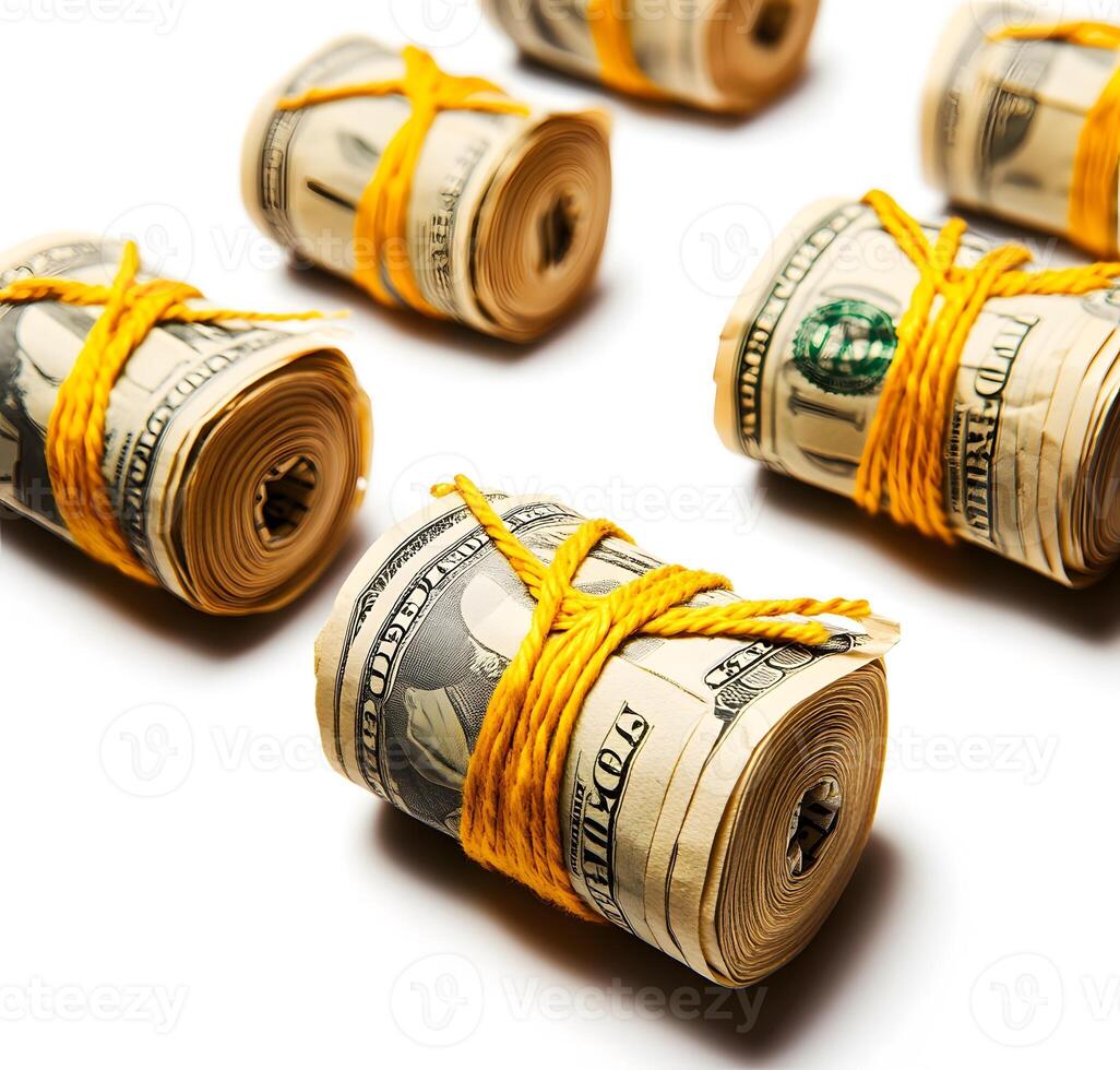 Rolled-up money bundles tied with yellow string. photo