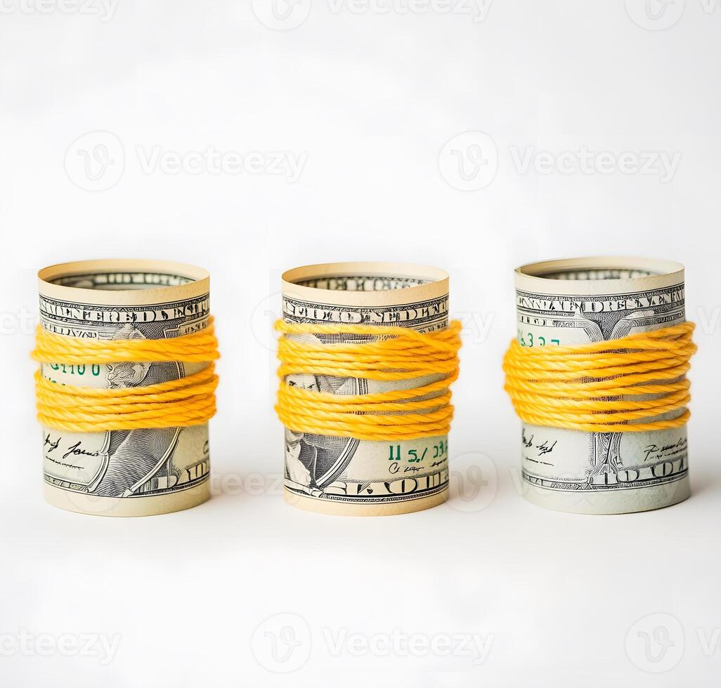Rolled-up us dollar bills bound with yellow string. photo