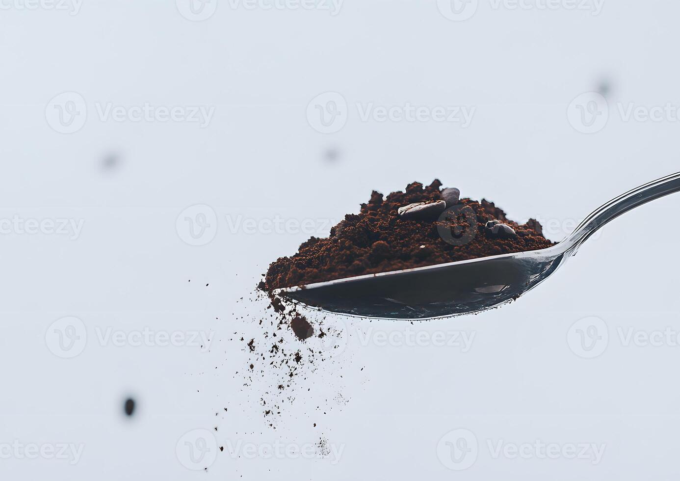 Coffee grounds spilling from a spoon. photo