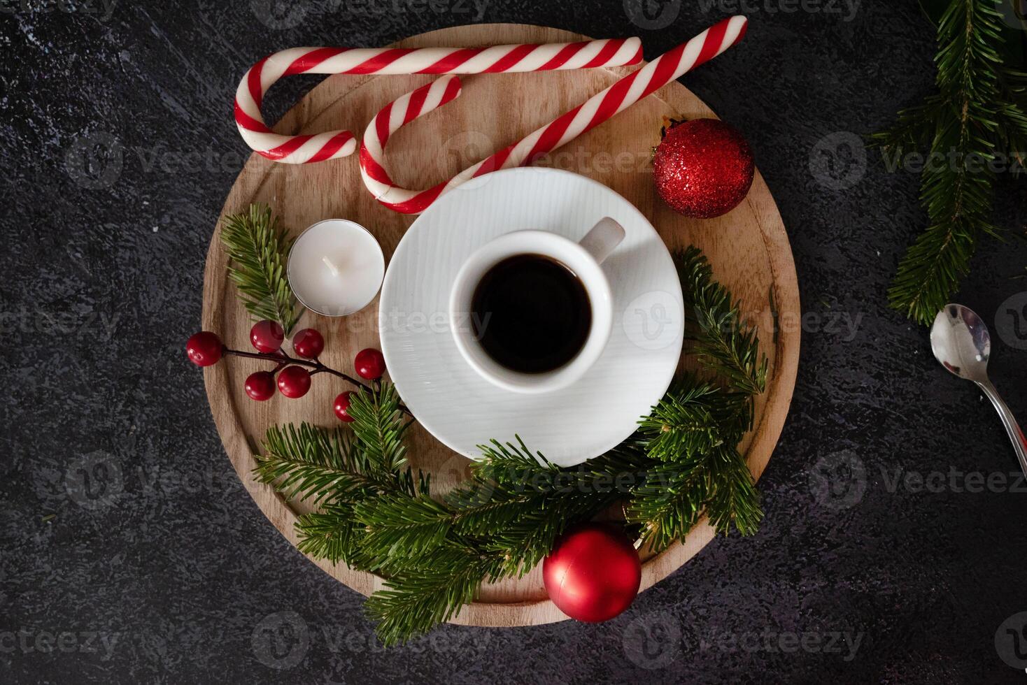 A top-down view of a cozy holiday scene showcasing festive elements like candy canes arranged in a heart, photo