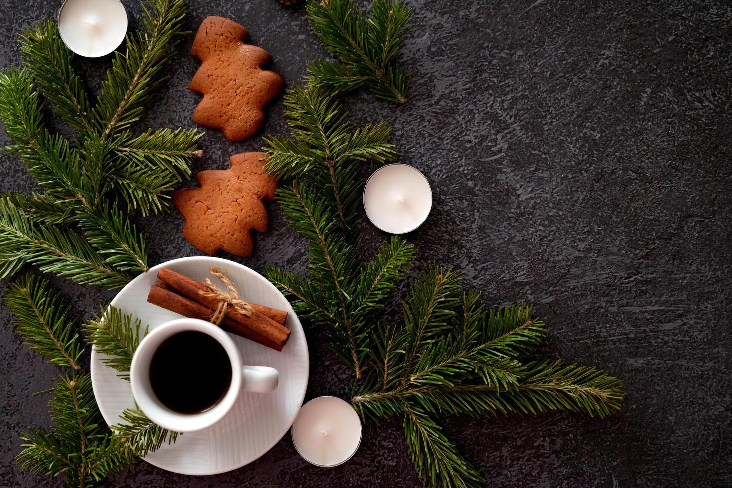Close-up of a Christmas table arrangement with candy canes in the shape of a heart, gingerbread cookies, cinnamon sticks photo
