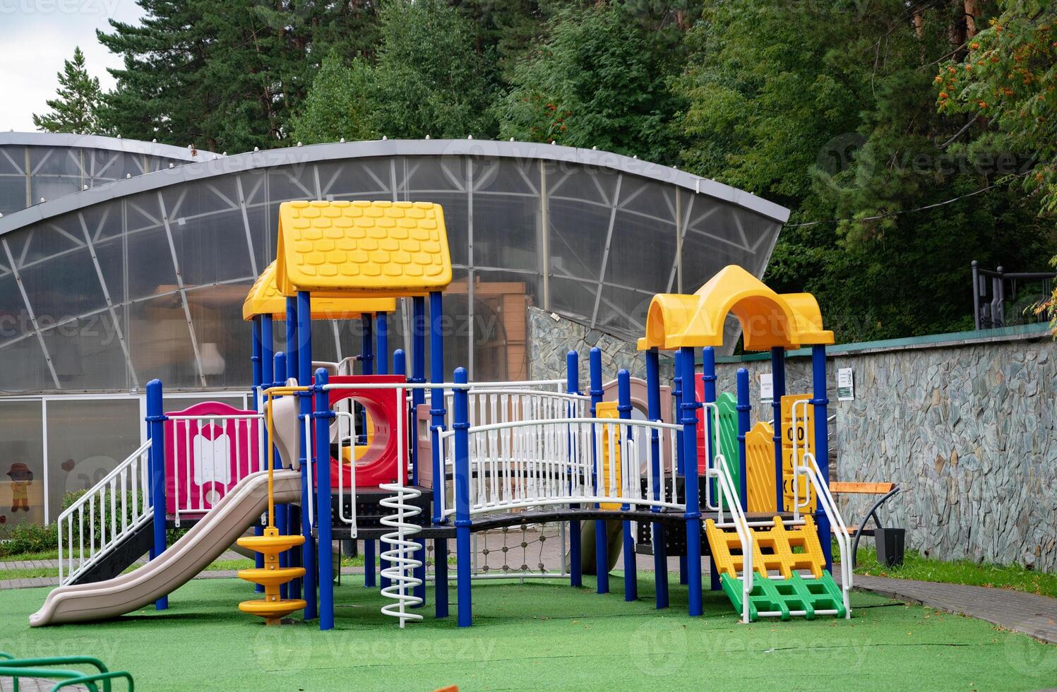 Colorful children's playground in a green park Community game. photo