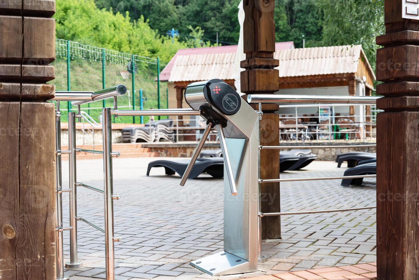 Entrance turnstile gate at swimming pool area on a sunny day. photo