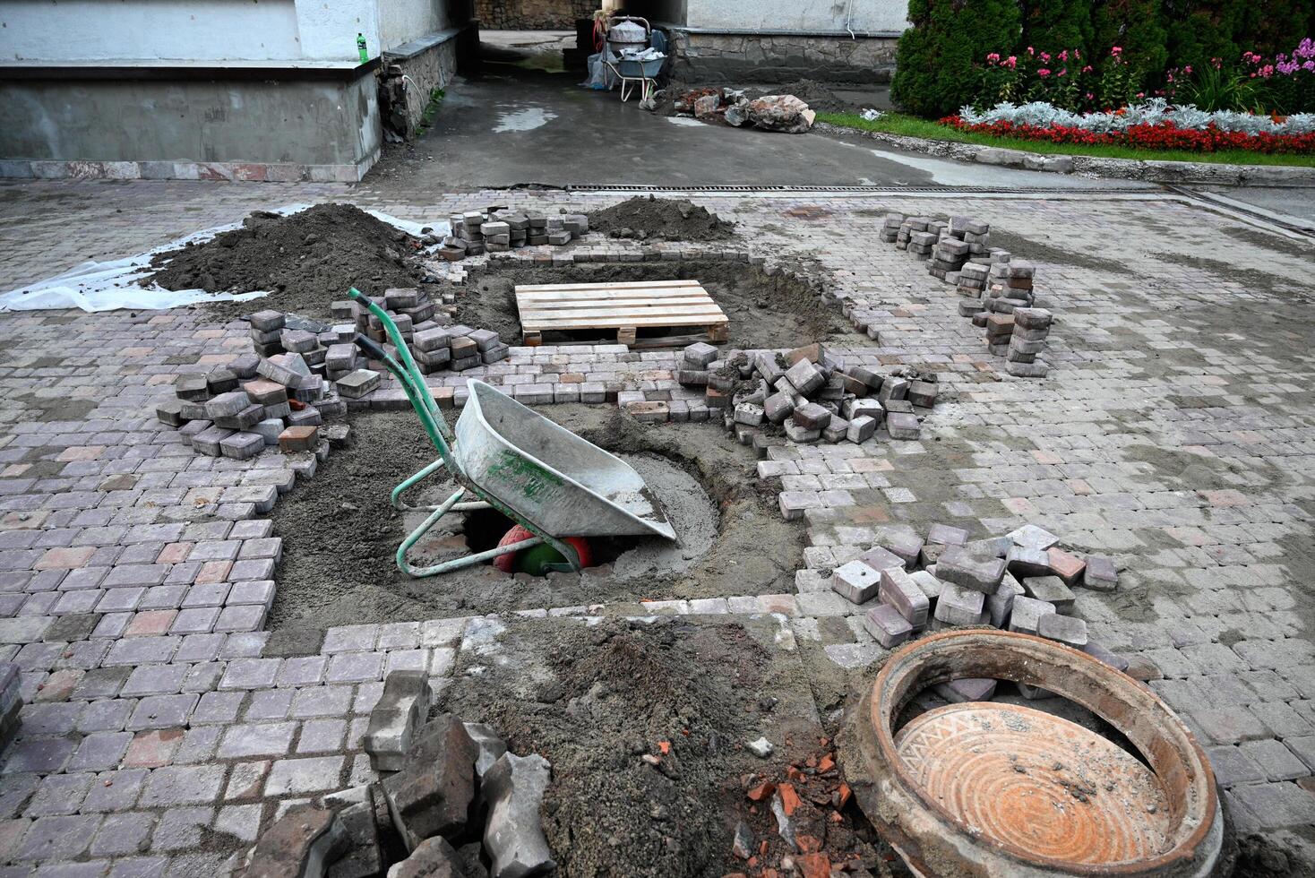 Low angle view of male hands measuring for precise pavement of the outside patio or sidewalk. Construction industry and renovation. photo