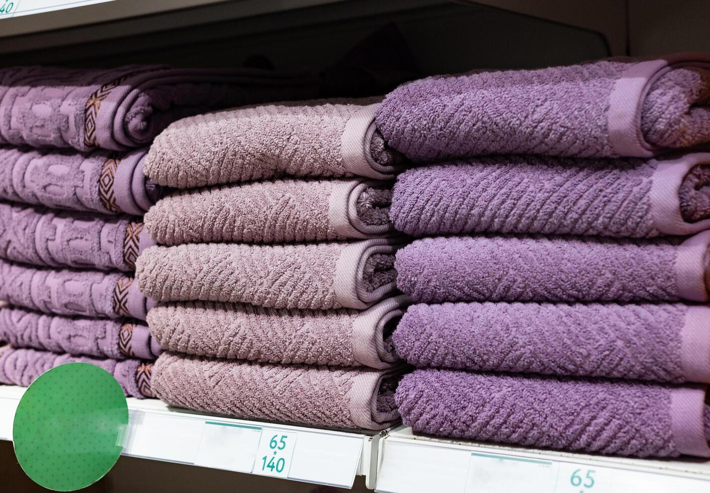 Multi colors Stack of bath towels. towels in a stack on the shelves in the supermarket. family shopping. photo