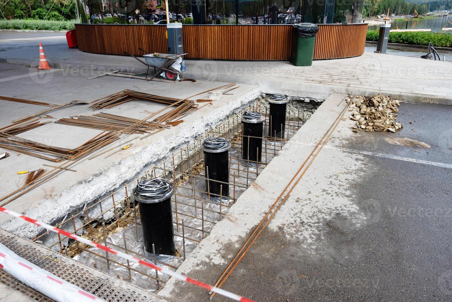 Construction site with rebar and concrete foundations on urban street. photo
