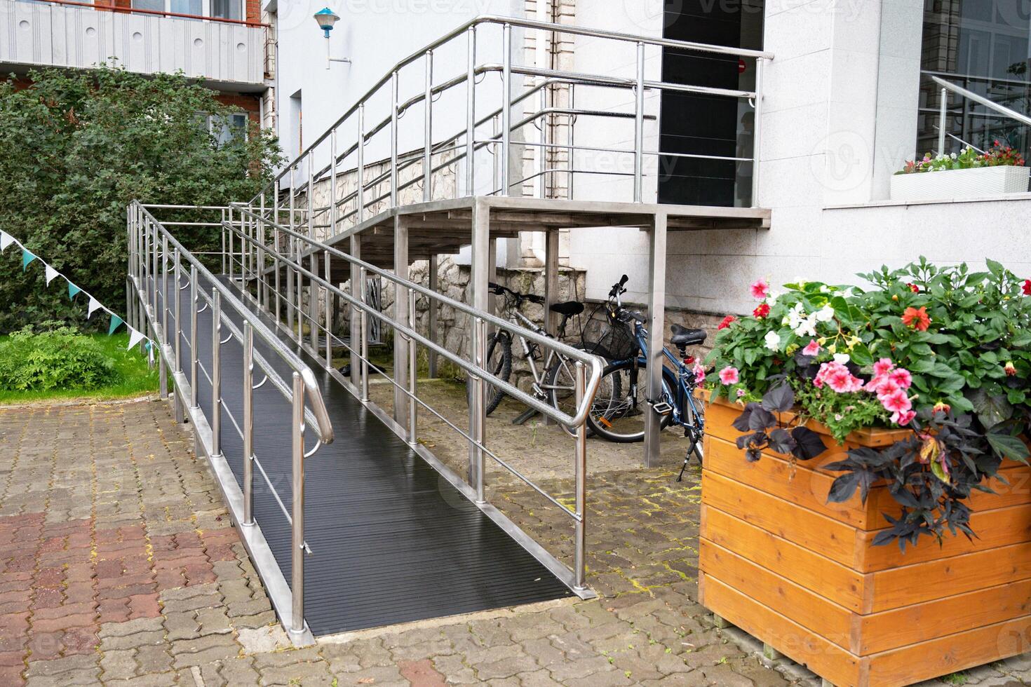 Modern building entrance with wheelchair ramp. photo