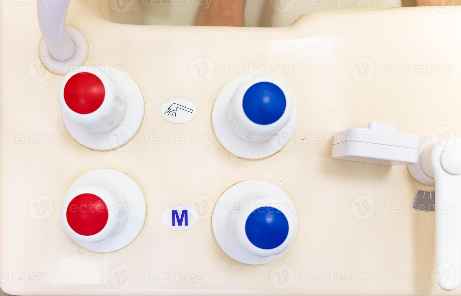 Timer and faucet handles on the bathtub in close-up. Temperature controller for spa treatments. photo