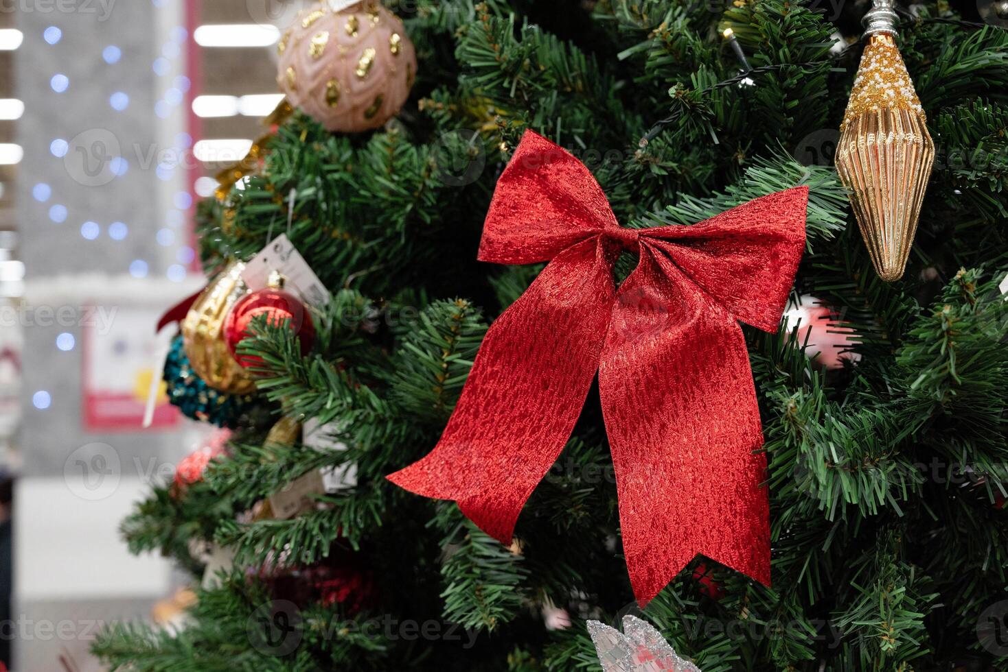 Christmas tree decorations featuring a red bow and ornaments. photo