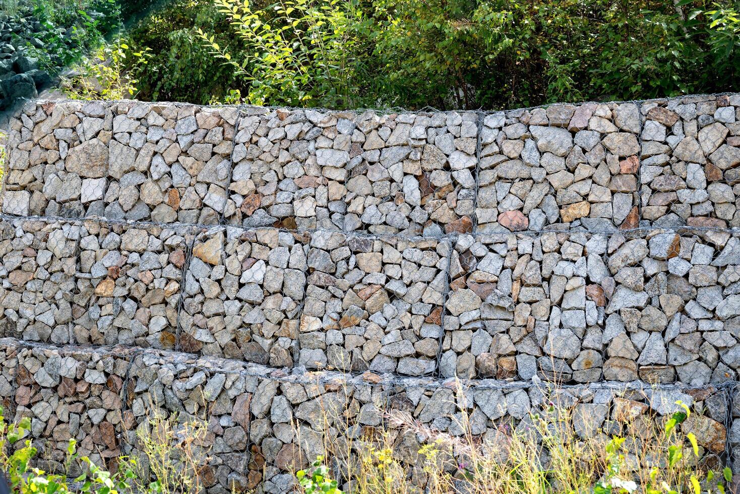 Stone gabion wall structure in nature. photo