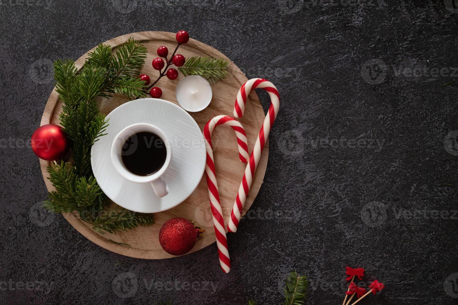 white coffee cup over frothy surface flat lay on green background with wooden house model, green plant, coffee beans and star anise. New year's resolutions for family. photo