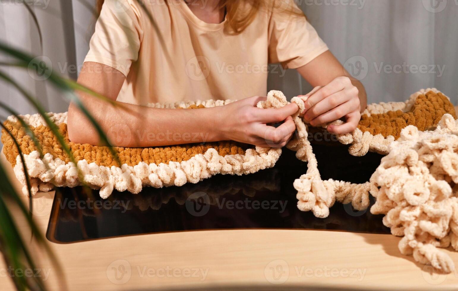 cozy indoor setting, showcasing a person working on a handmade textile piece using modern techniques photo