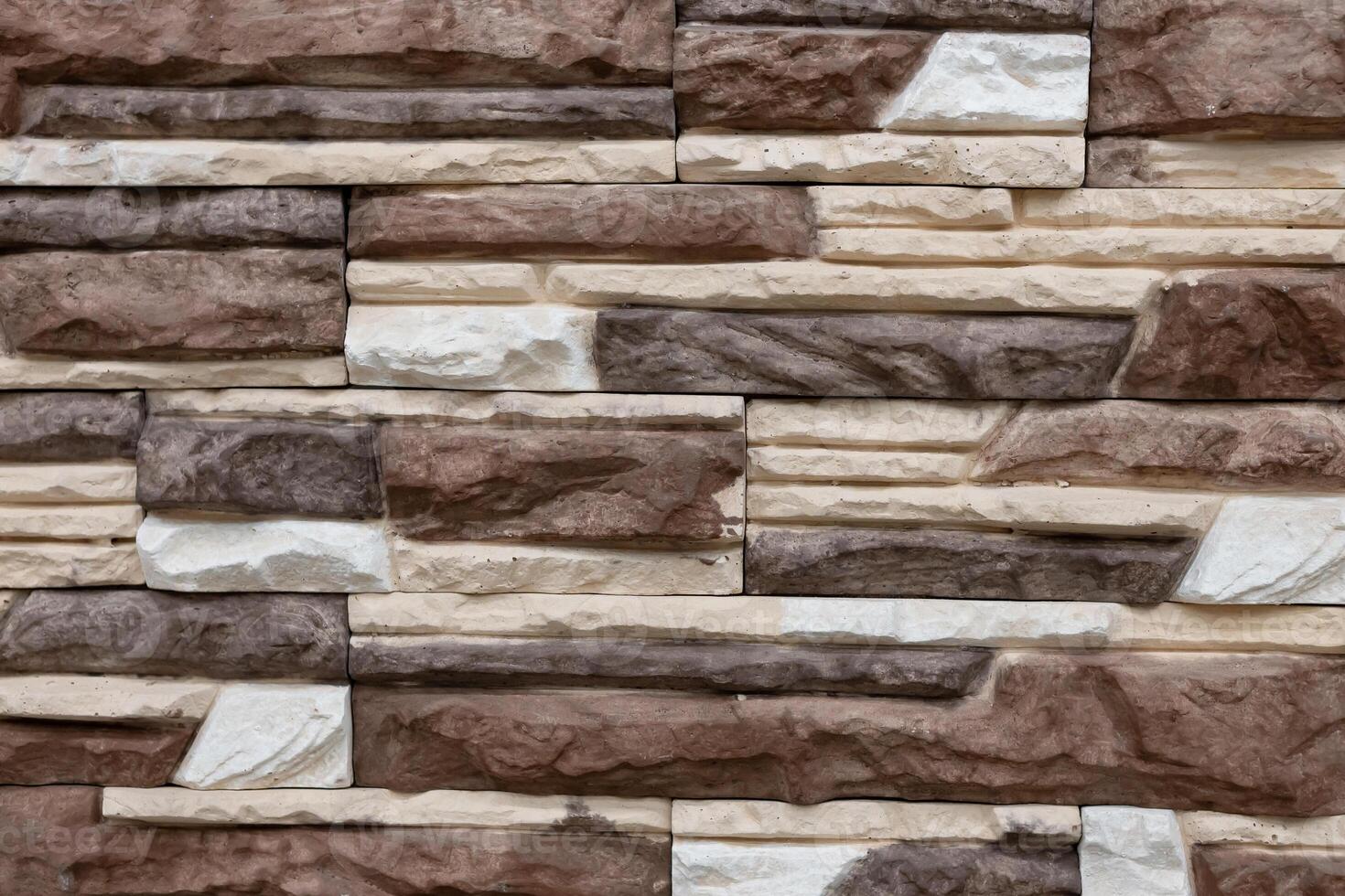 Variety of textured stone wall with neutral colors showcasing craftsmanship in architectural design photo