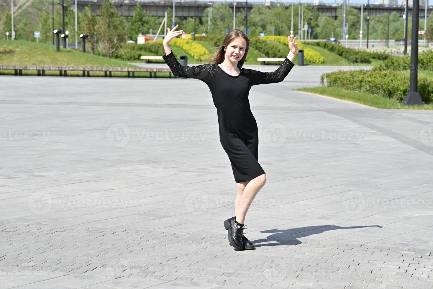The setting appears to be outdoors, possibly near a modern building or art installation. photo