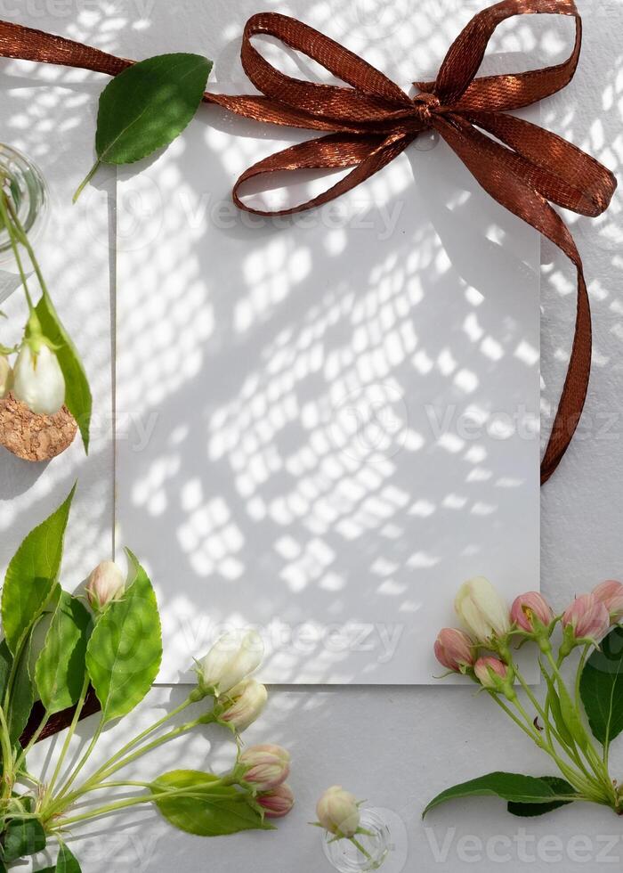 Relaxing tea experience with a cup of herbal tea and fresh blossoms on a serene white table setting during springtime photo