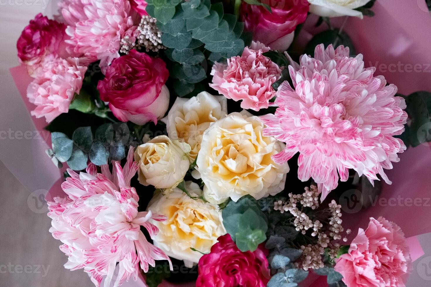 Beautiful bouquet of pink and white flowers arranged elegantly for a special occasion in a cozy setting photo