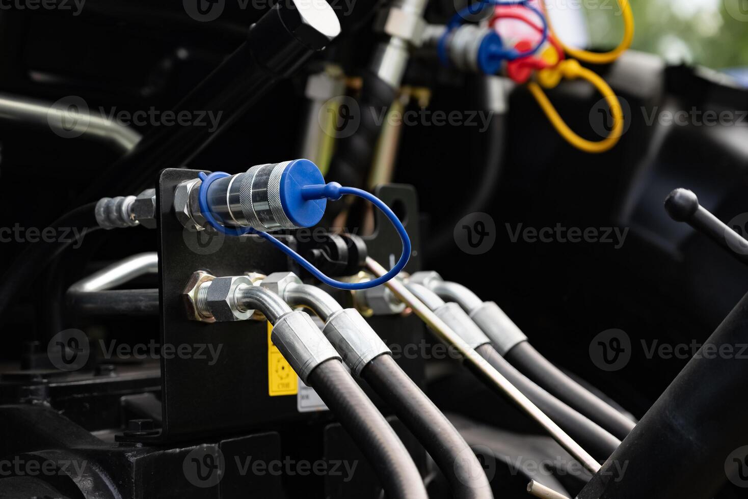 Close-up of hydraulic hoses and connectors on machinery equipment. photo