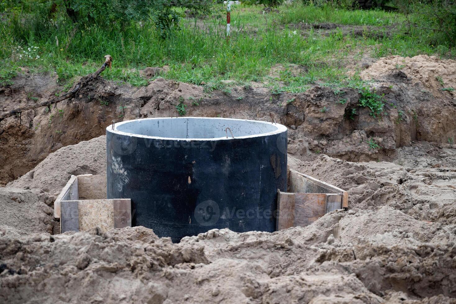 Drainage hole beside a newly paved road . photo