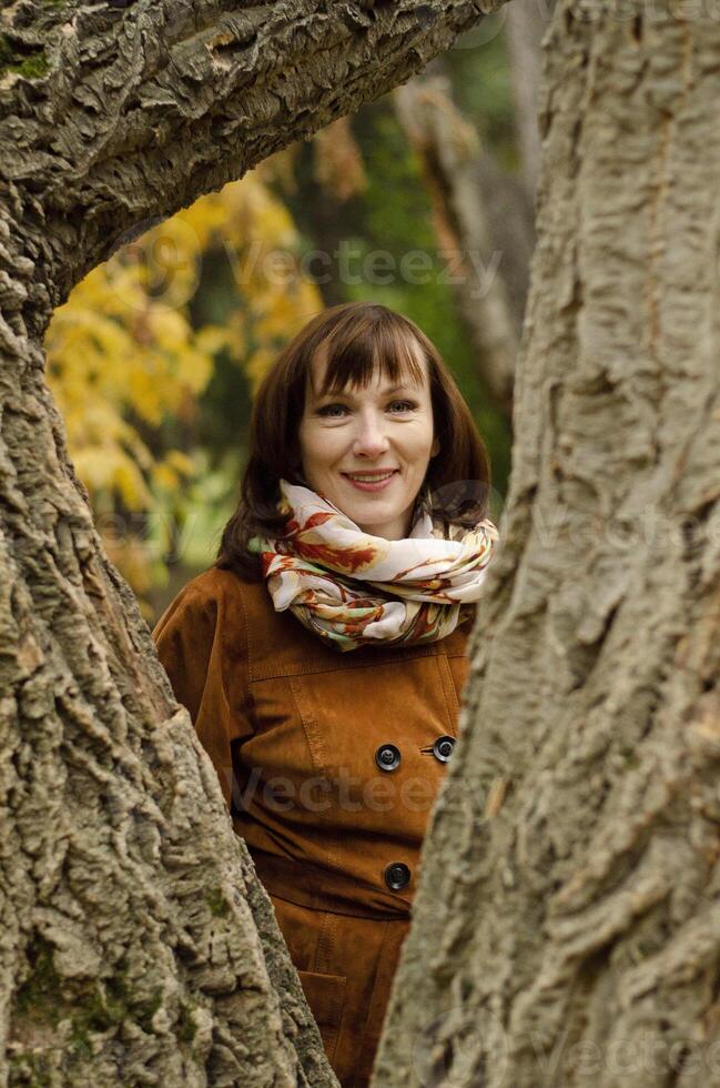 The scene captures a moment of quiet connection with nature, with the woman blending into the natural surroundings. photo