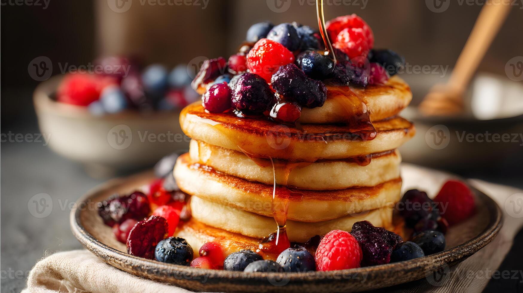 Delicious pancakes topped with layers of fresh mixed berries and golden amber syrup drizzle photo