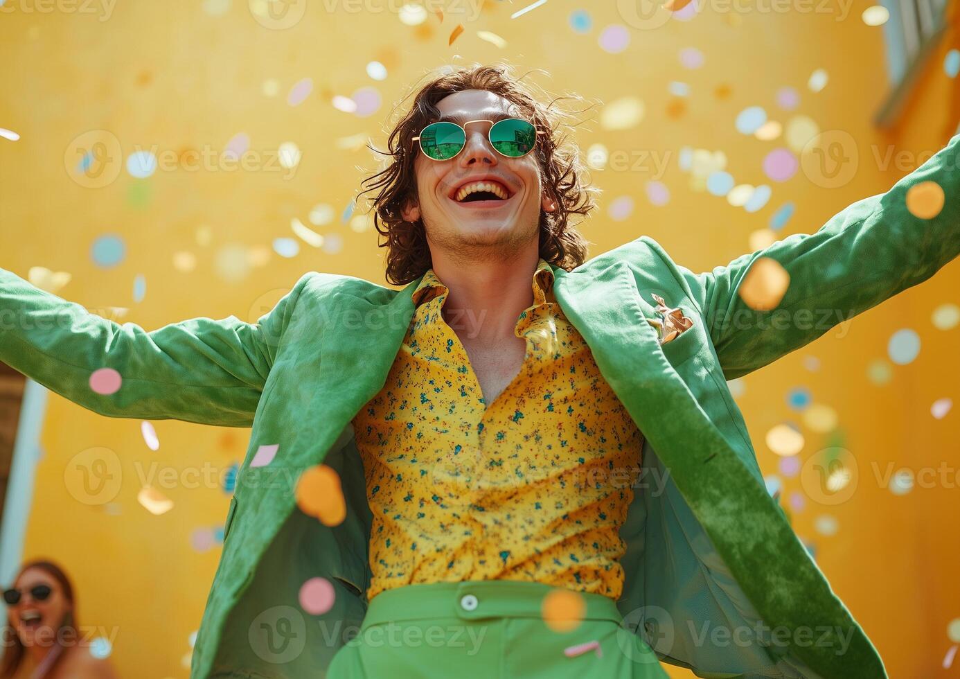 A man in a green suit and sunglasses is throwing confetti photo