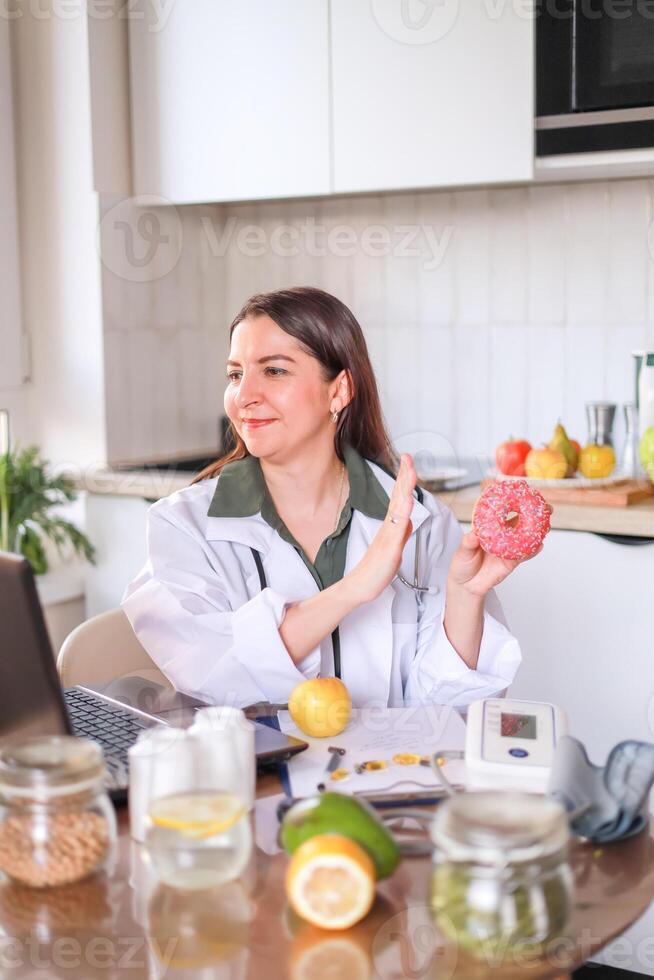 A nutritionist explains the harm of a sweet donut to health and its connection with obesity and diseases. The concept of healthy eating and diet. photo