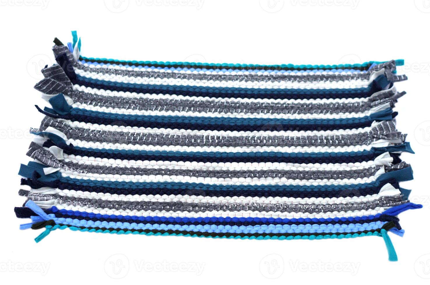 Handwoven recycled fabric rug made from upcycled textile scraps, transforming old clothes into eco-friendly functional home decor to reduce textile waste White background photo