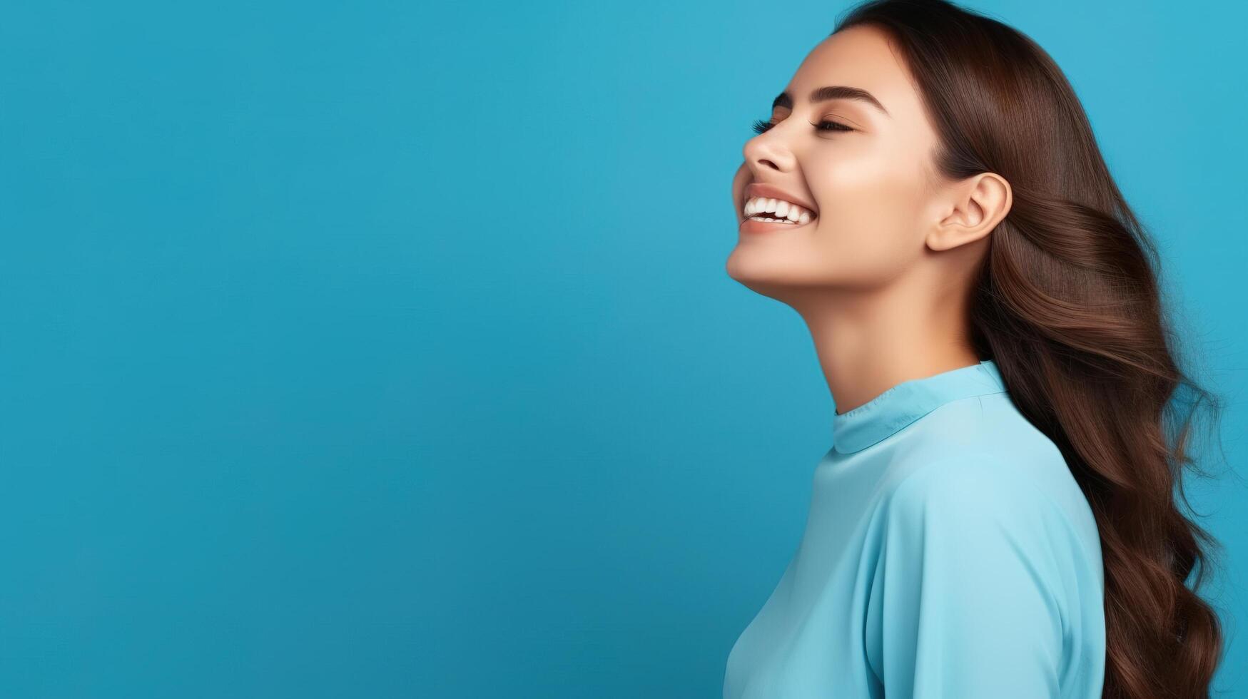 A woman with long hair smiling and looking up photo
