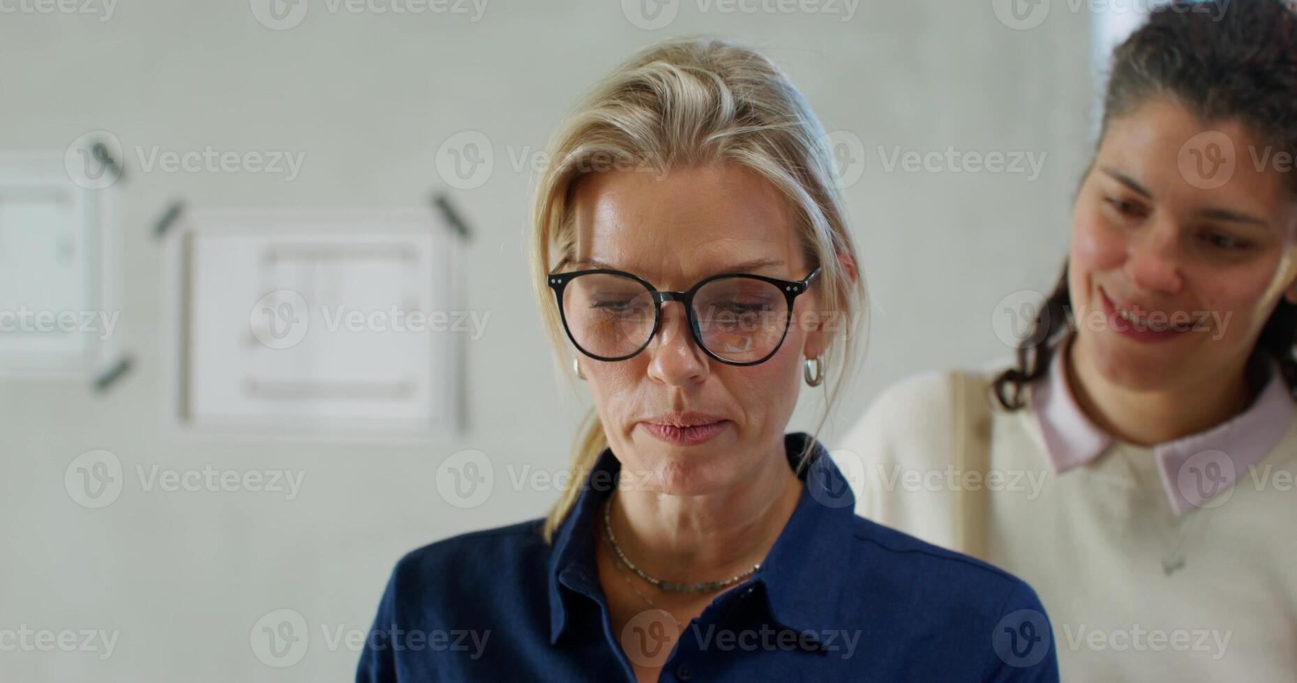 The designer shows the design of the room on a tablet to happy customers photo
