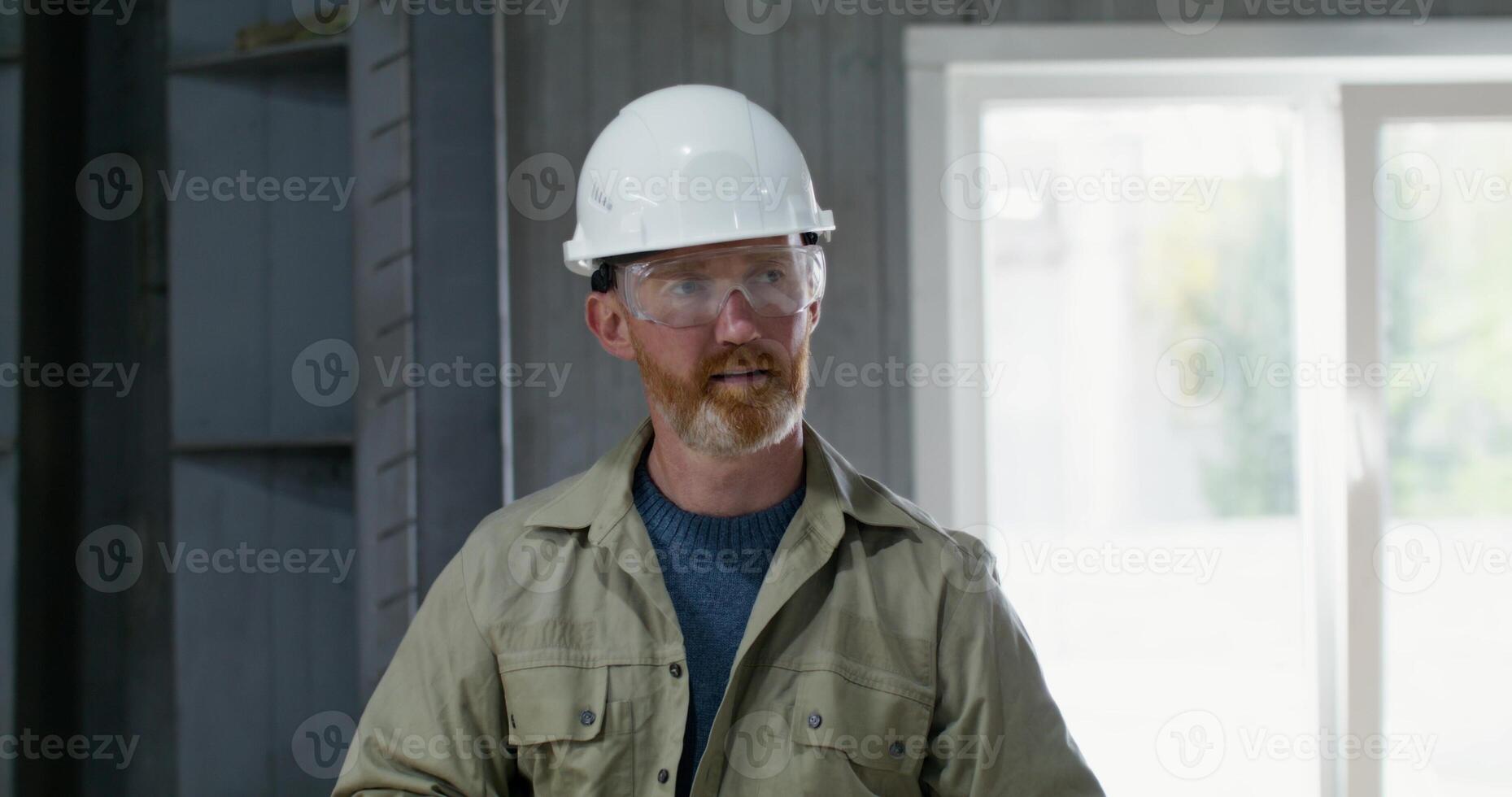 Two men are working intently at a cardboard factory. They check the quality of the cardboard photo