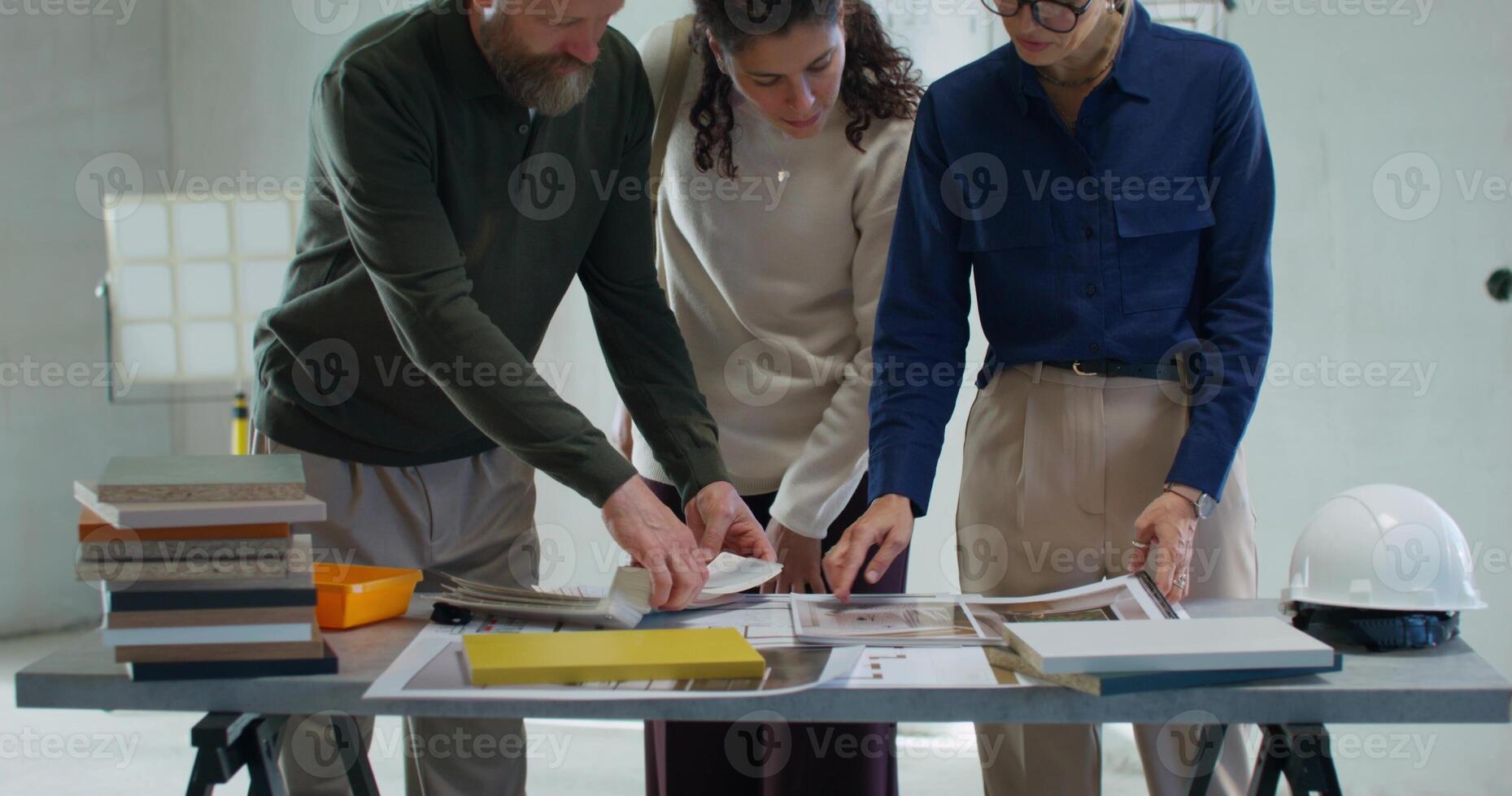 Coordination of the design project at the construction site. The designer talks to the customers photo