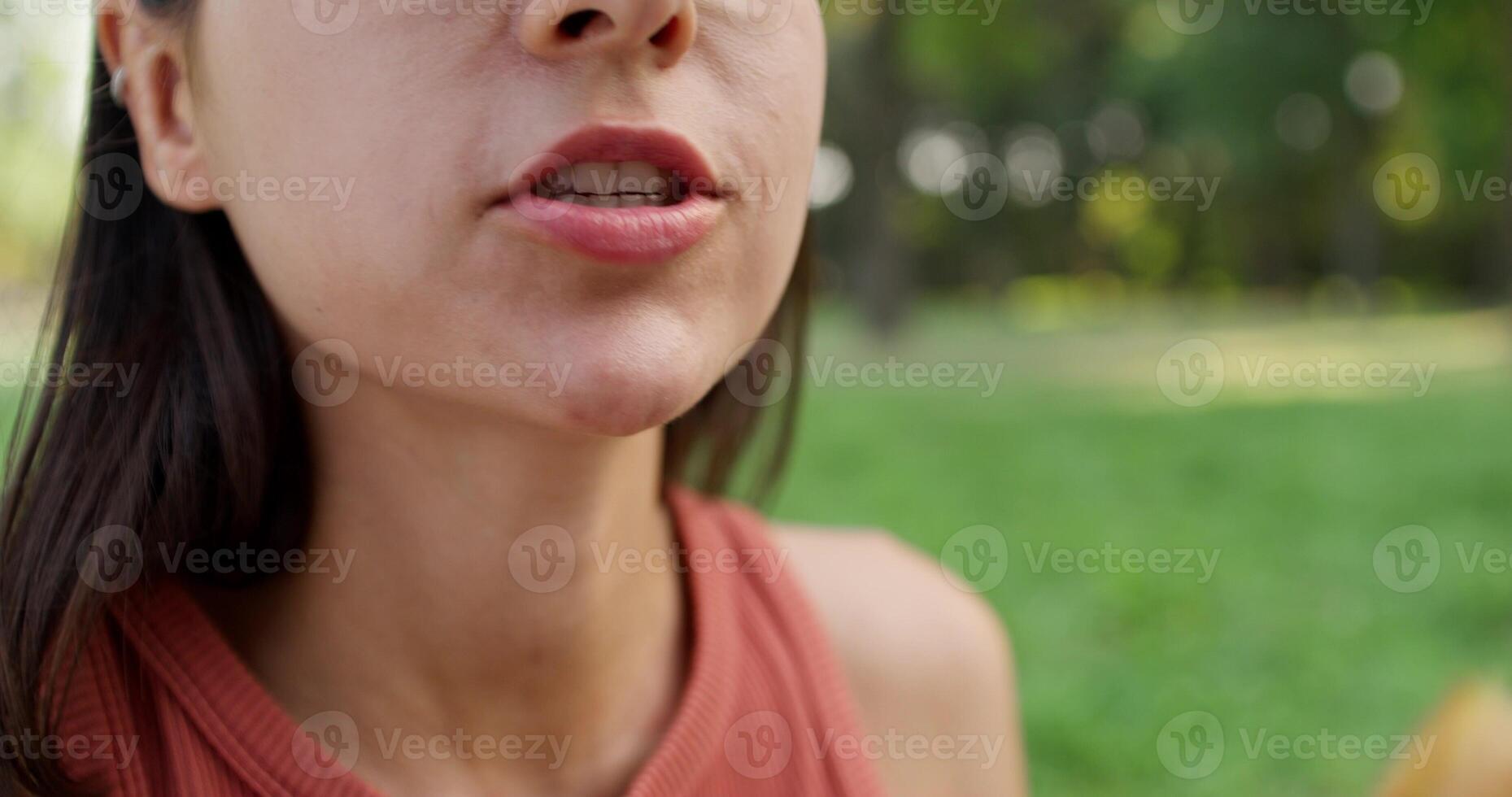 A woman is eating a piece of bread photo