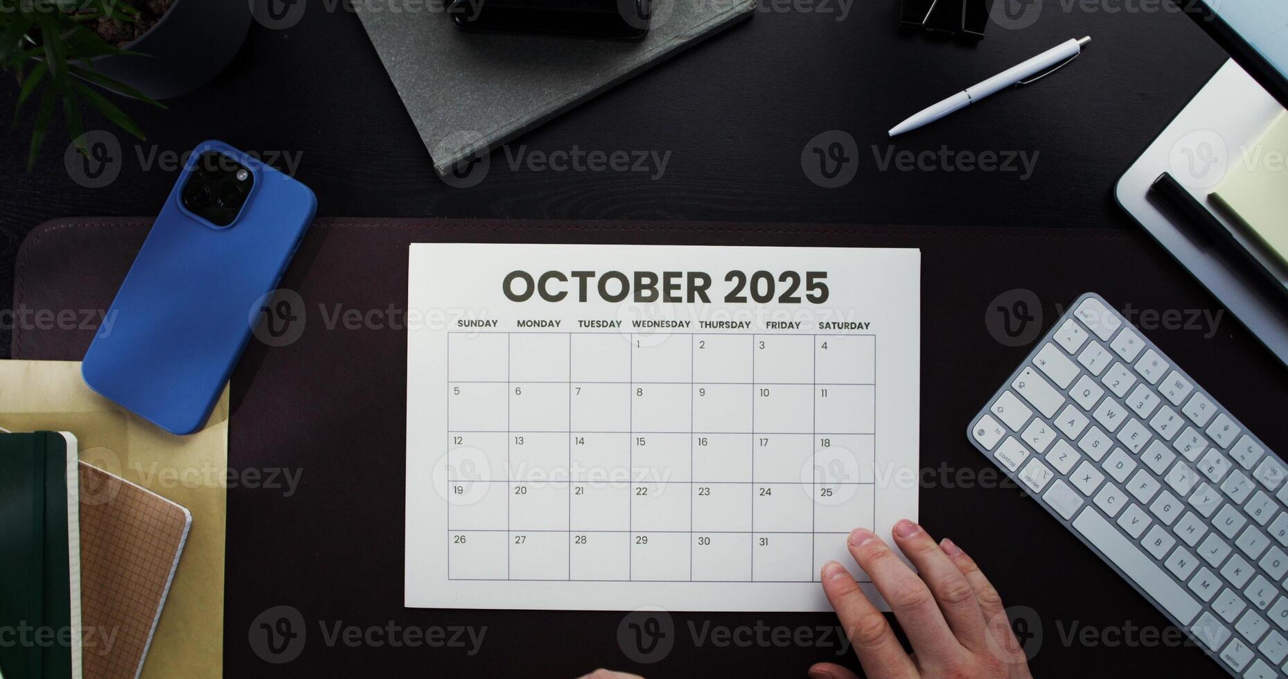 October 2020 calendar on desk with laptop and coffee photo