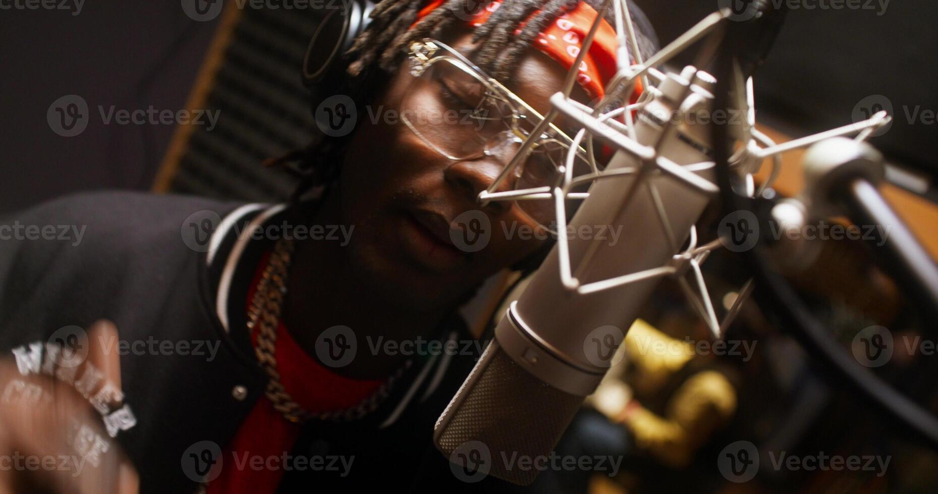 Close-up of a man's face while he recording a song in the studio. He sings into the microphone photo