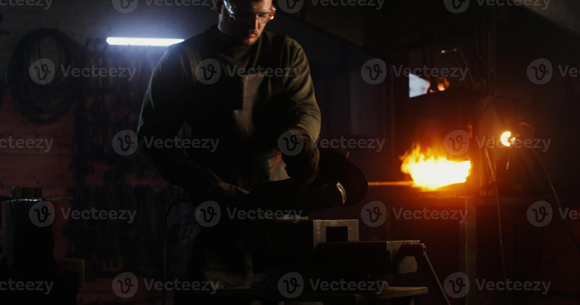 A man is working on a piece of metal photo