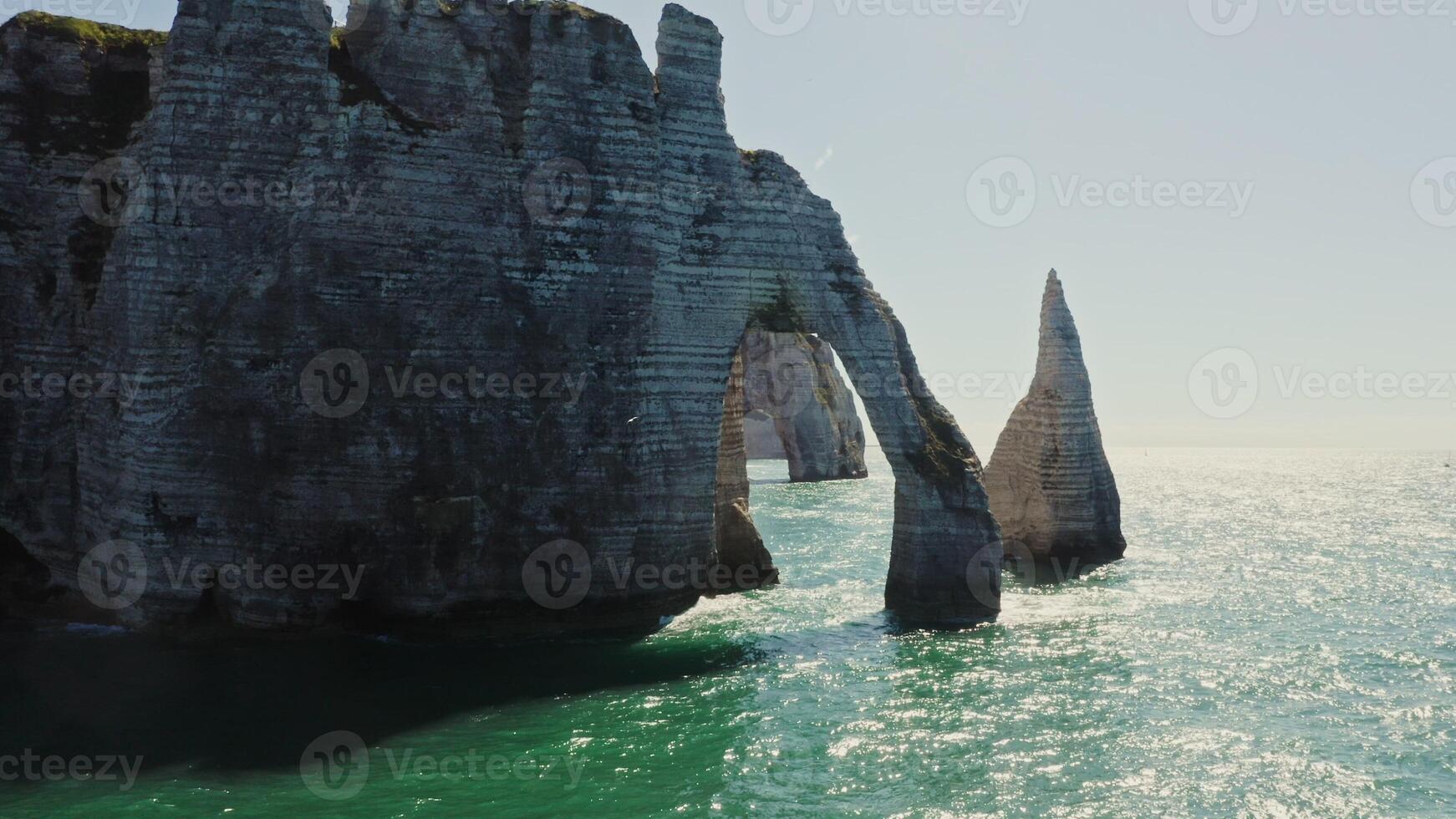 Natural monument of France, the most picturesque place on the bank of the English Channel - sheer cliffs with natural arches, washed by water sparkling in the sun, Etretat photo