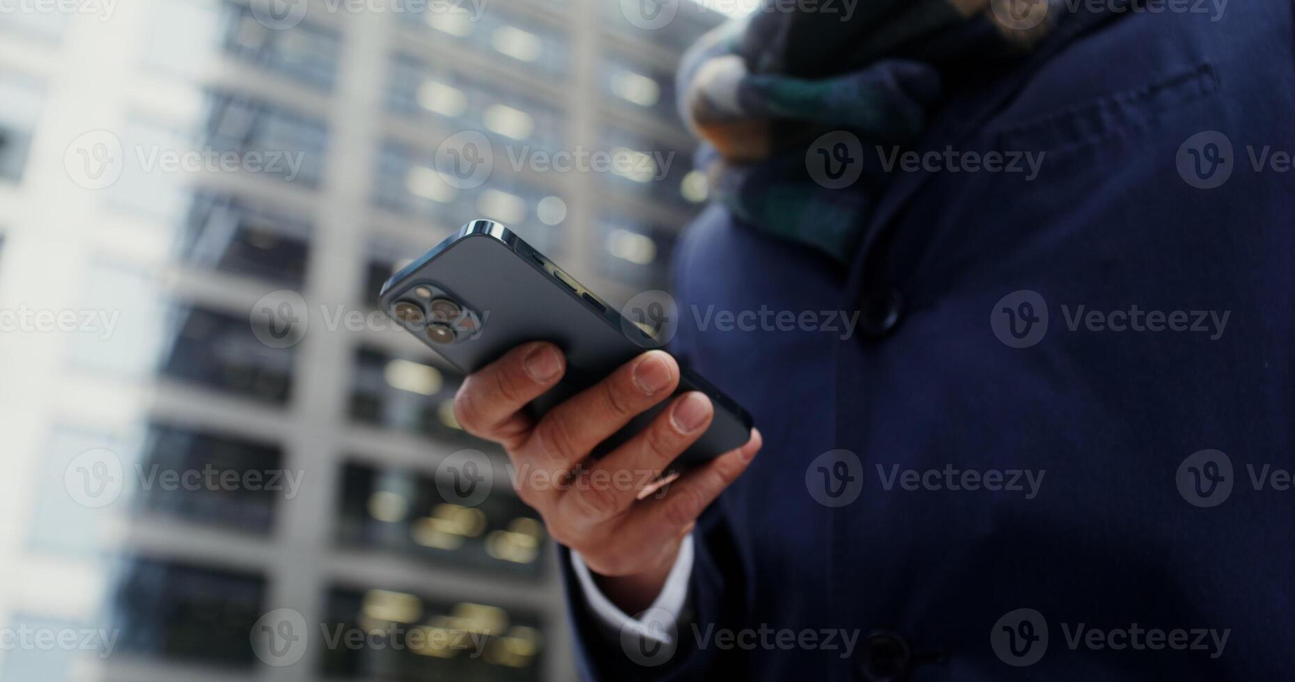 Close-up of male hands typing on a mobile phone, viewed from below. No face, unrecognizable person. in 4k, red komodo photo