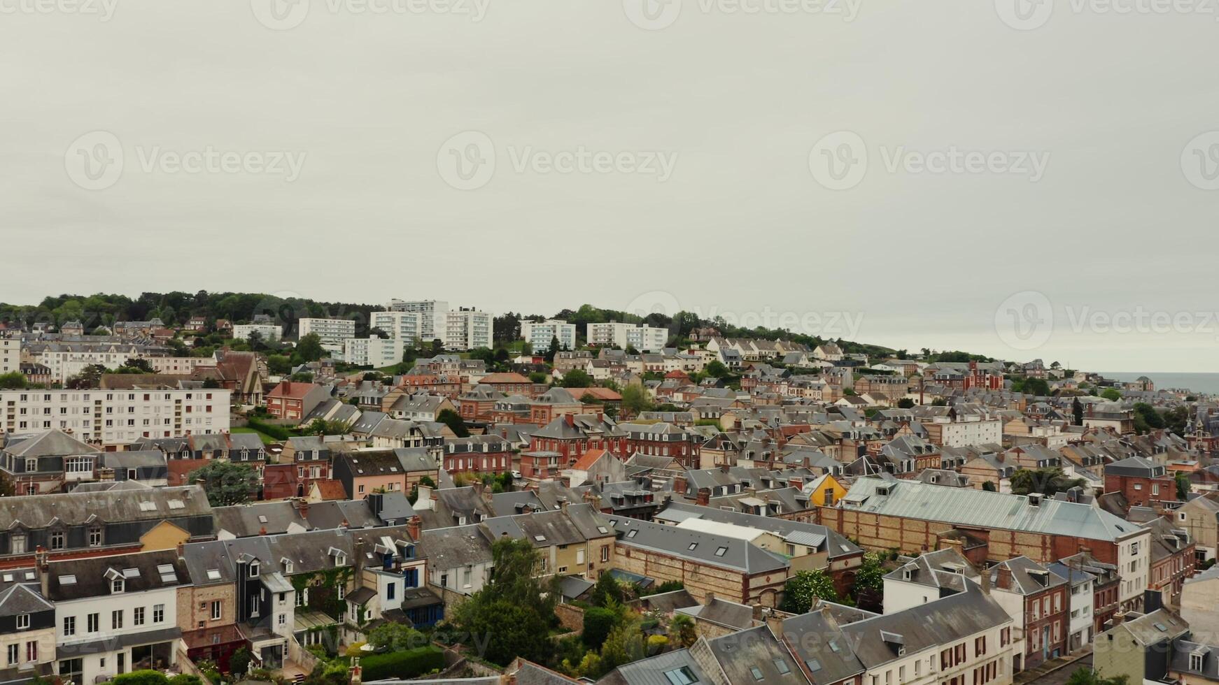 Horizontal panning from a drone, a view of an old European city located on a hill near the sea. Traditional houses and modern buildings, bird's eye view. France photo