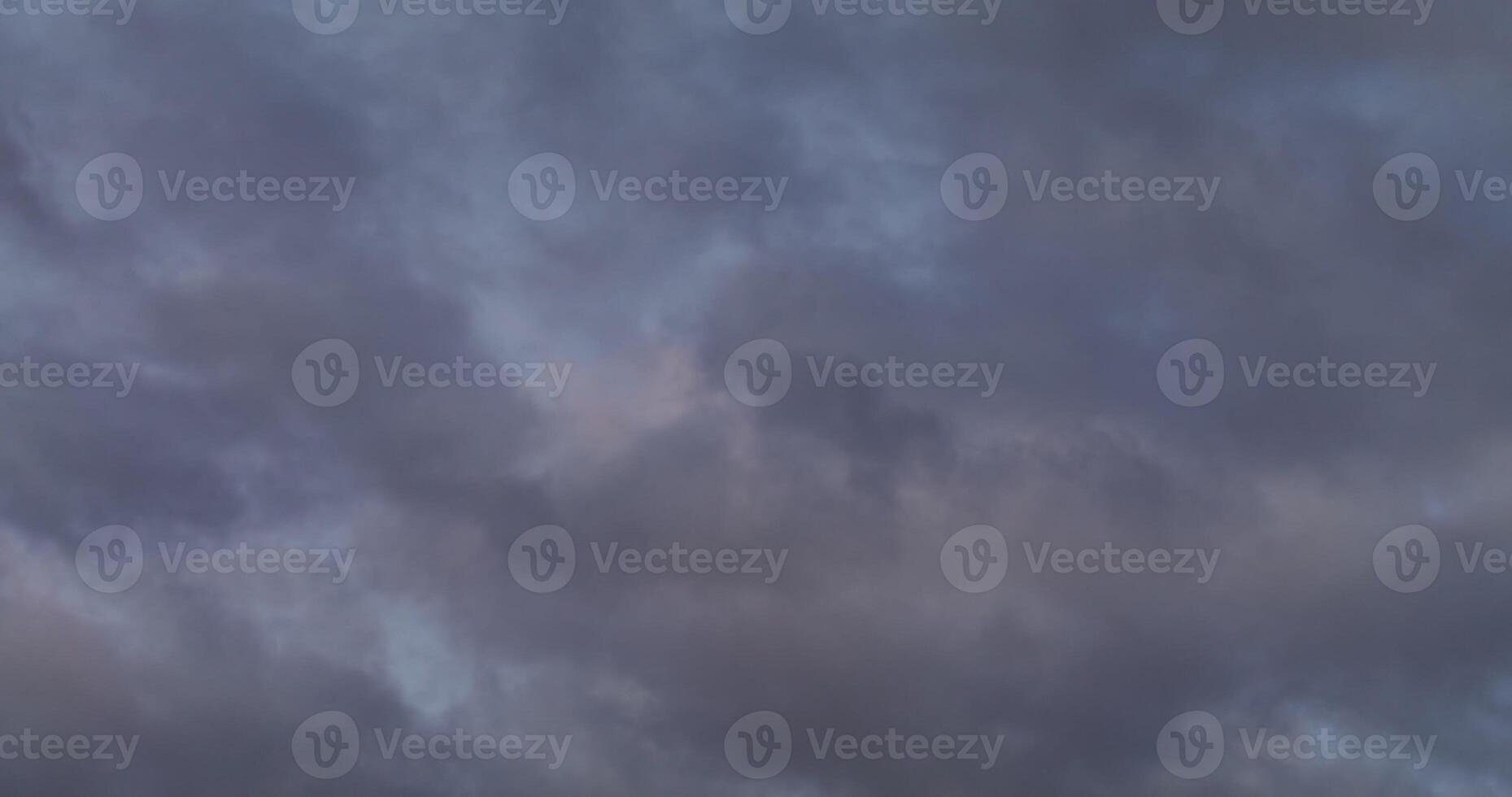 View of the sky covered with gray clouds with a pink reflection of the setting sun. in 4 k, red komodo. photo