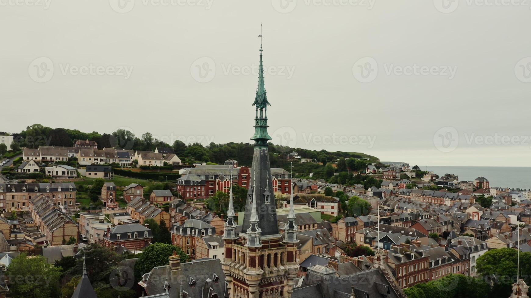 Benedictine palace in F camp in northern France. Bird's-eye , a view of the tower and spire of the palace from a drone. View of the historic city center with traditional houses. photo
