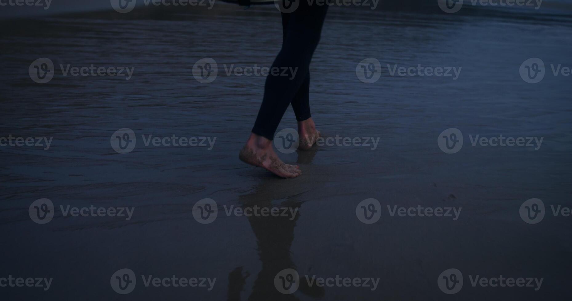A person walking on the beach at night photo