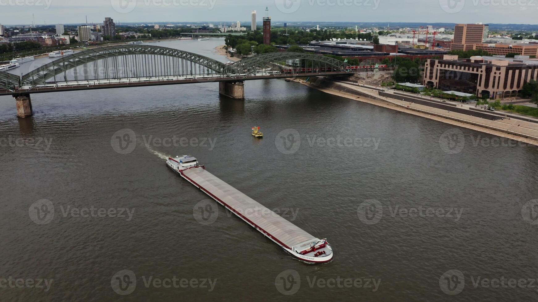 A large empty ferry floats along the Rhine River, which flows through the historic center of Cologne. Wide river Rhine from a bird's eye view. Beautiful places in Germany, Cologne, drone . photo