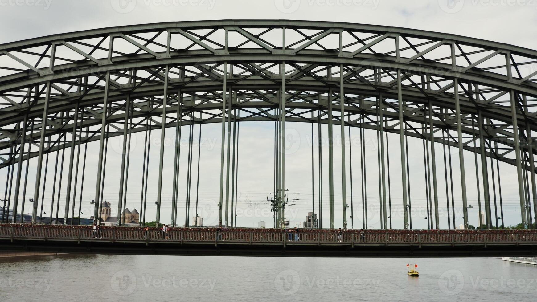Drone , view of the railway-pedestrian bridge in the city of Cologne. Many people across the wide river Rhine on a beautiful bridge. Drone from the direction of the river. photo